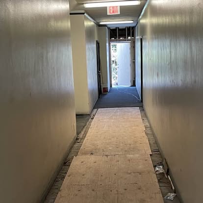 Interior corridor with protective floor covering during renovation